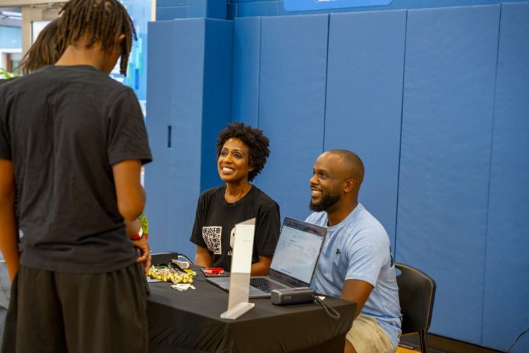 a women and man at a sponsor table
