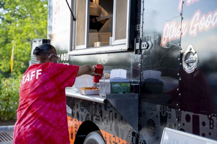 women eating urban burger at the food truck