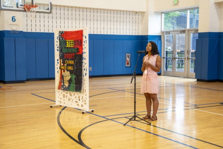 woman giving speech at juneteenth event