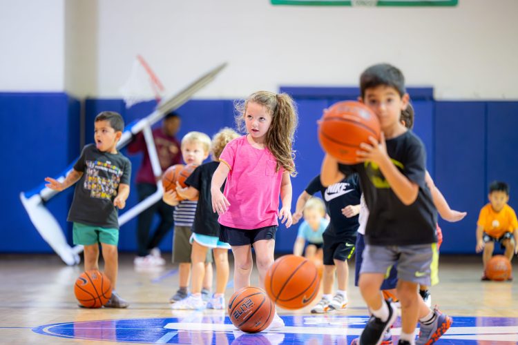 young children playing basketball